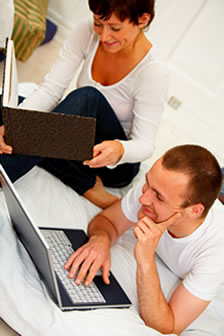 Photo of a couple with a laptop